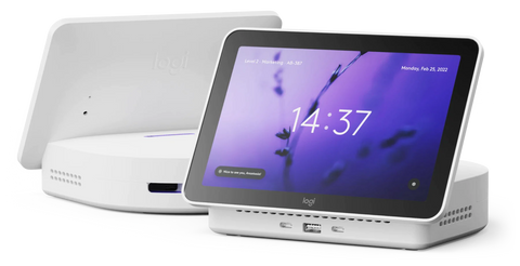 An image of two Logi Dock Flex devices. One has its screen facing the camera that shows a clock in the centre, today's date and other information on a purple background. The other Logi Dock Flex is facing the other way and only its back is visible.